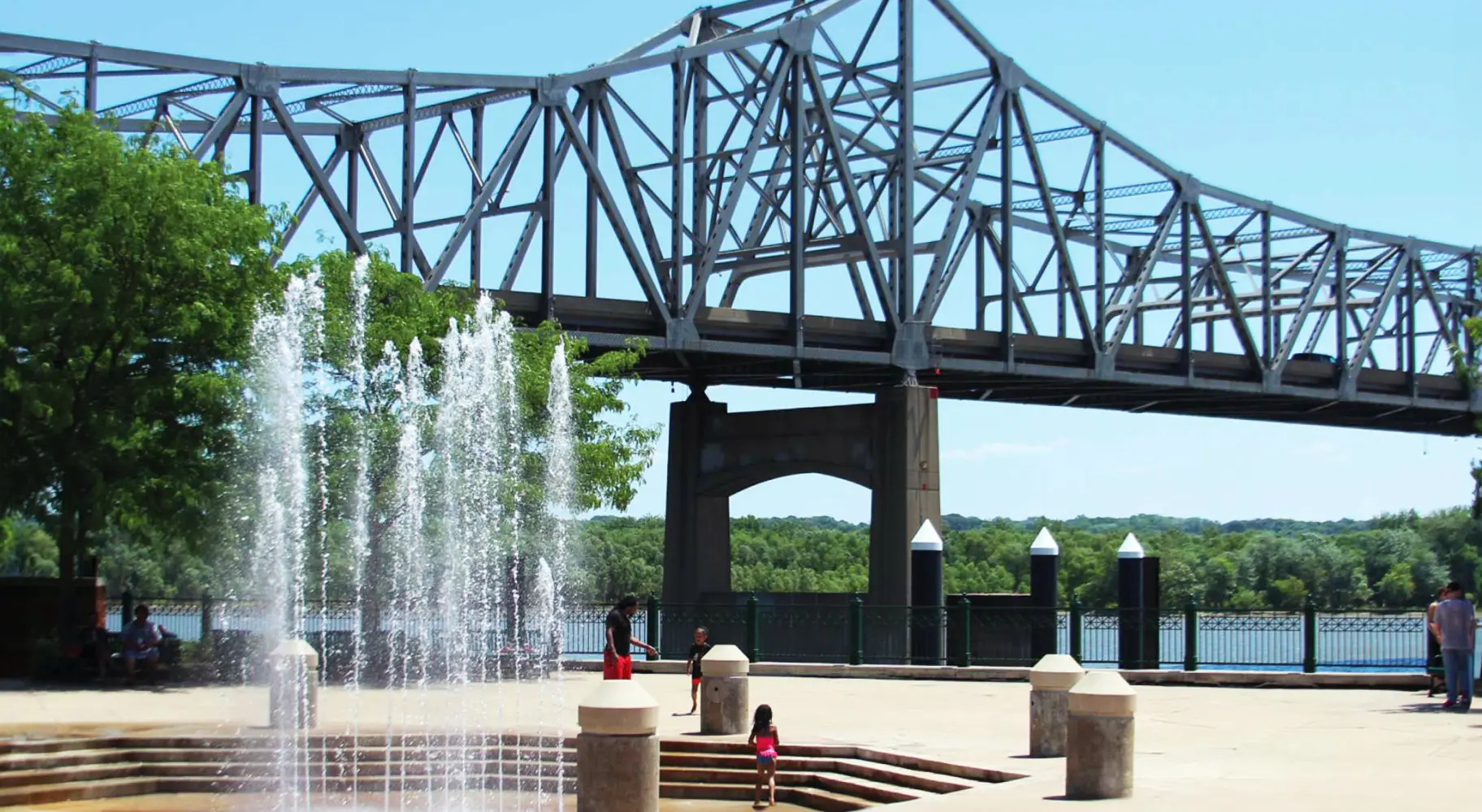 A fountain in front of a bridge crossing the Illinois River in Peoria