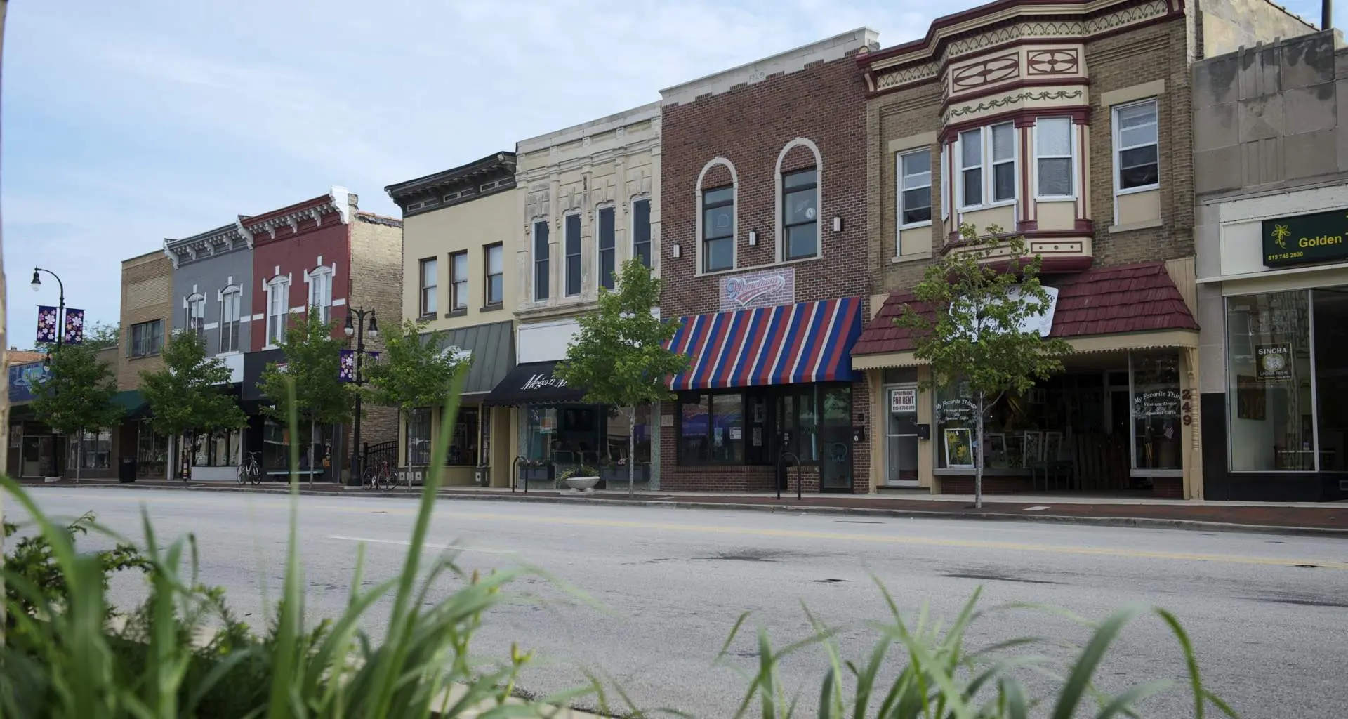 Line of storefronts down a main street in downtown DeKalb
