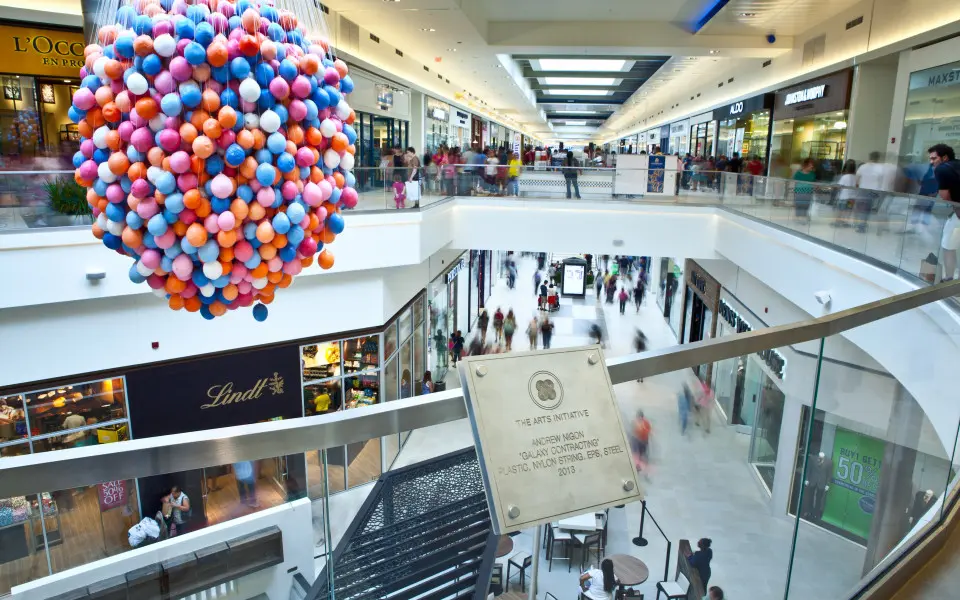 A view of stores and shoppers from an upper level of Fashion Outlets of Chicago