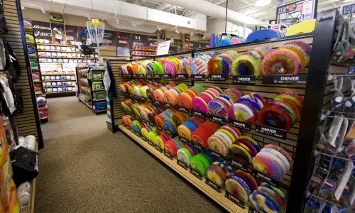 A colorful rack of Frisbees tempts shoppers at a sporting goods store in Illinois.
