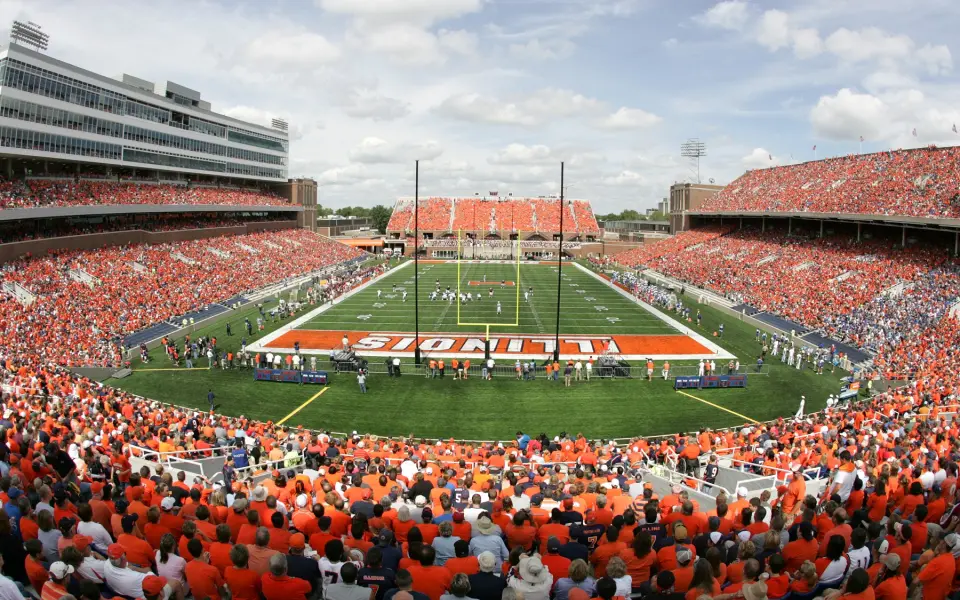 A crowded football stadium on game day, with many spectators dressed in orange