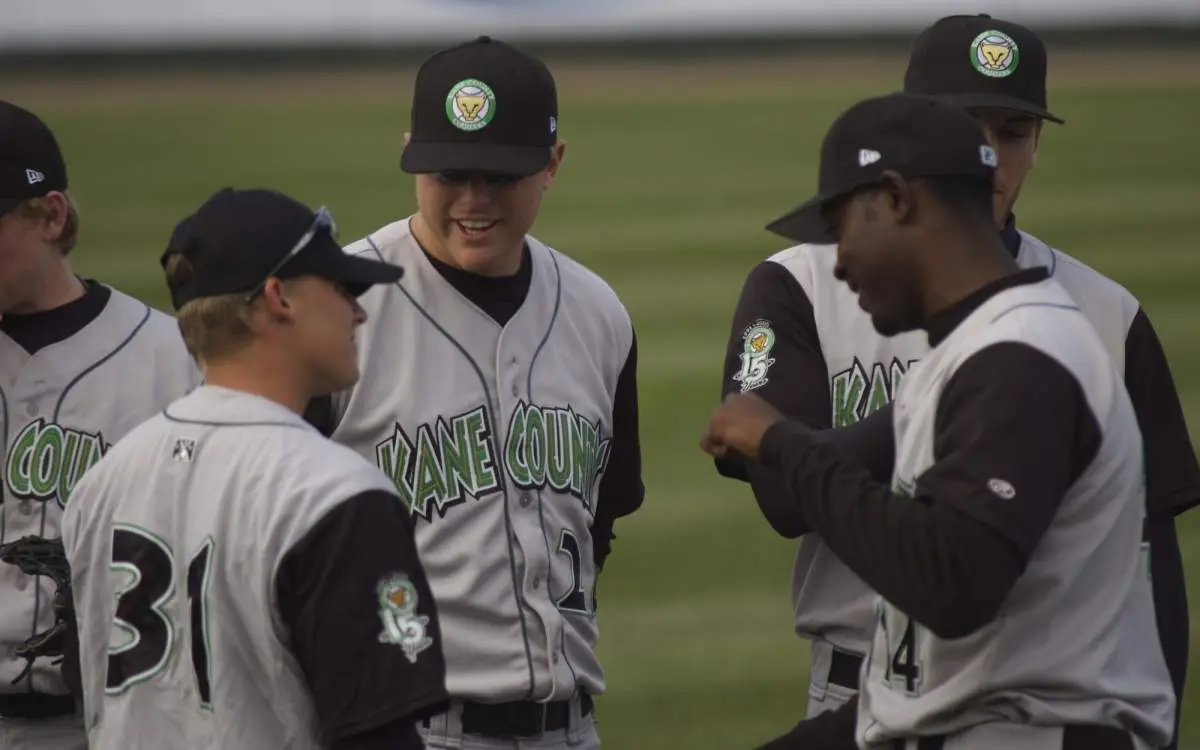 Players talk strategy at a Kane County Cougars game